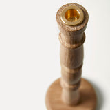 Wooden and brass candle holder on a white background