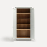 White painted freestanding tall cupboard Shaker style with panelled doors black metal knobs. Both doors open revealing oak interior and four shelves.