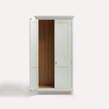 White painted freestanding tall Armoire cupboard Shaker style with panelled doors and black metal knobs. Shown face on with one door open.
