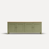 Green painted four door shaker style sideboard with black metal door knobs and oak worktop.