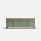 Green painted four door shaker style sideboard with black metal door knobs and oak worktop.