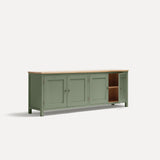 Green painted four door shaker style sideboard with black metal door knobs and oak worktop. Shown at an angle one door open.