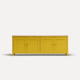 Yellow painted four door shaker style sideboard with black metal door knobs and oak worktop.