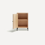 Single door ply wood contemporary bedside cabinet with green painted door open to left revealing internal shelf, black metal door knobs and black metal legs. Shown at an angle.