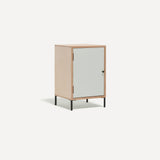 Single door ply wood contemporary bedside cabinet with white painted door, black metal door knobs and black metal legs. Shown at an angle.