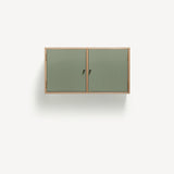 Two door ply wood contemporary wall cupboard with green painted doors, black metal door knobs.