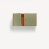 Two door ply wood contemporary wall cupboard with green painted doors (one open showing internal shelf), black metal door knobs.