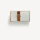 Two door ply wood contemporary wall cupboard with white painted doors (one open revealing internal shelf), black metal door knobs.