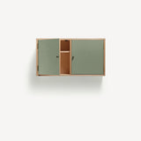 Two door ply wood contemporary wall cupboard with green painted doors (one open showing internal shelf), black metal door knobs.