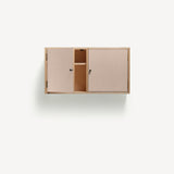 Two door ply wood contemporary wall cupboard with pink painted doors (one open showing internal shelf), black metal door knobs.