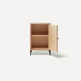 Single door ply wood contemporary bedside cabinet with blue grey painted door open to right revealing internal shelf, black metal door knobs and black metal legs