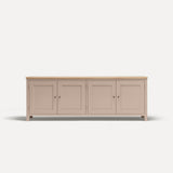 Pink painted four door shaker style sideboard with black metal door knobs and oak worktop.