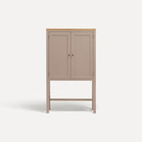 Pink painted two door shaker style cabinet on tall legs with oak work top.