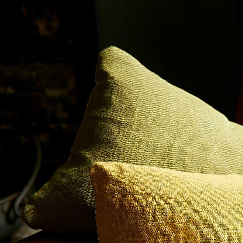 Green linen scatter cushion with a yellow one.
