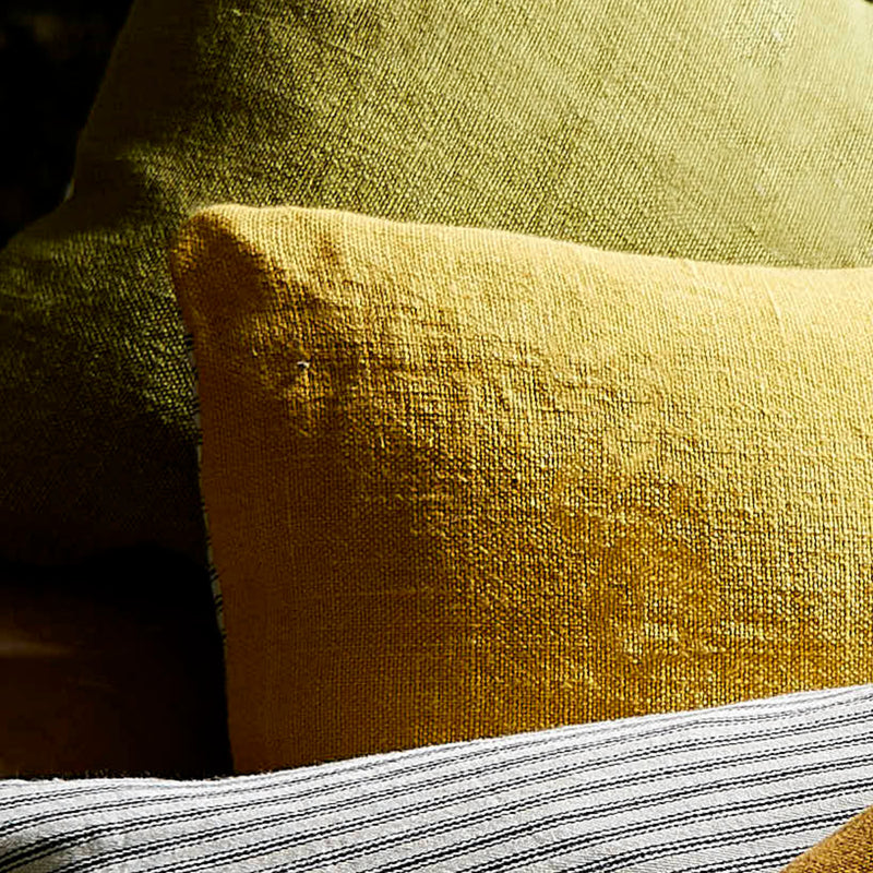Yellow linen scatter cushion with a green one and cotton ticking.