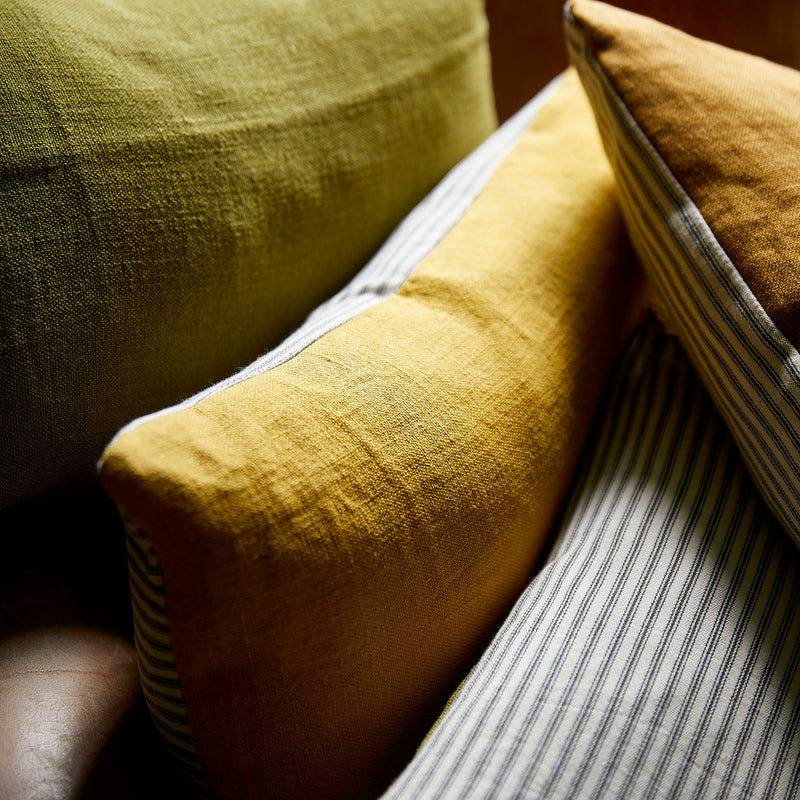 Green, ochre and mustard linen cushions with cotton ticking