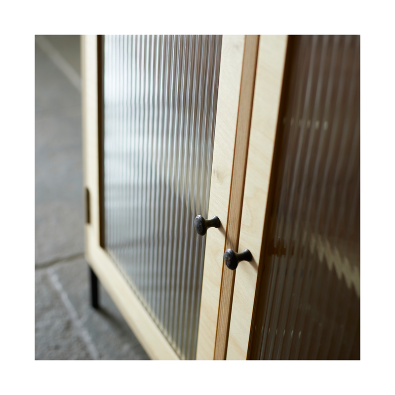 Two doors glazed with obscure reeded glass and black metal door knobs.