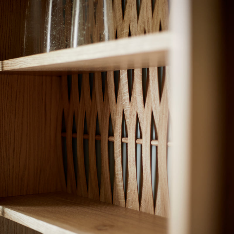 Close up of shelving unit showing woven wood back.