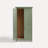 Green painted freestanding tall Armoire cupboard Shaker style with panelled doors and black metal knobs. Shown face on with one door open.