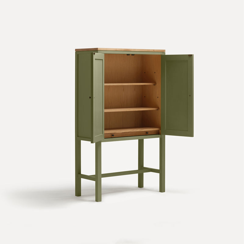 Green painted two door shaker style cabinet on tall legs with oak work top. Doors open revealing oak interior and sliding shelf. Shown at an angle.