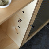 Close up shot showing inside ply wood cabinet with metal shelf supports.