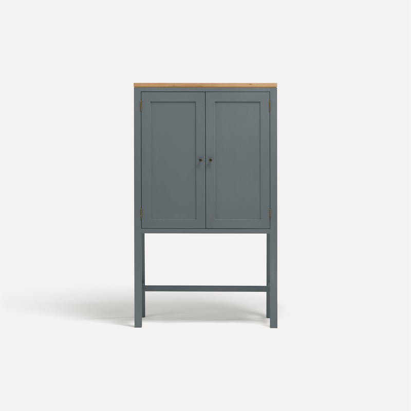 Blue painted two door shaker style cabinet on tall legs with oak work top. 