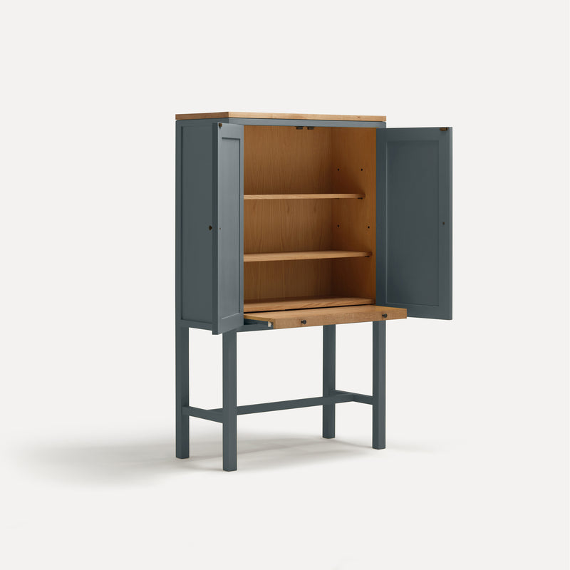 Blue painted two door shaker style cabinet on tall legs with oak work top.  Shown at angle doors open with sliding shelf extended.