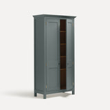 Blue Grey painted freestanding tall cupboard Shaker style with panelled doors black metal knobs. Shown at an angle with one door slightly open.