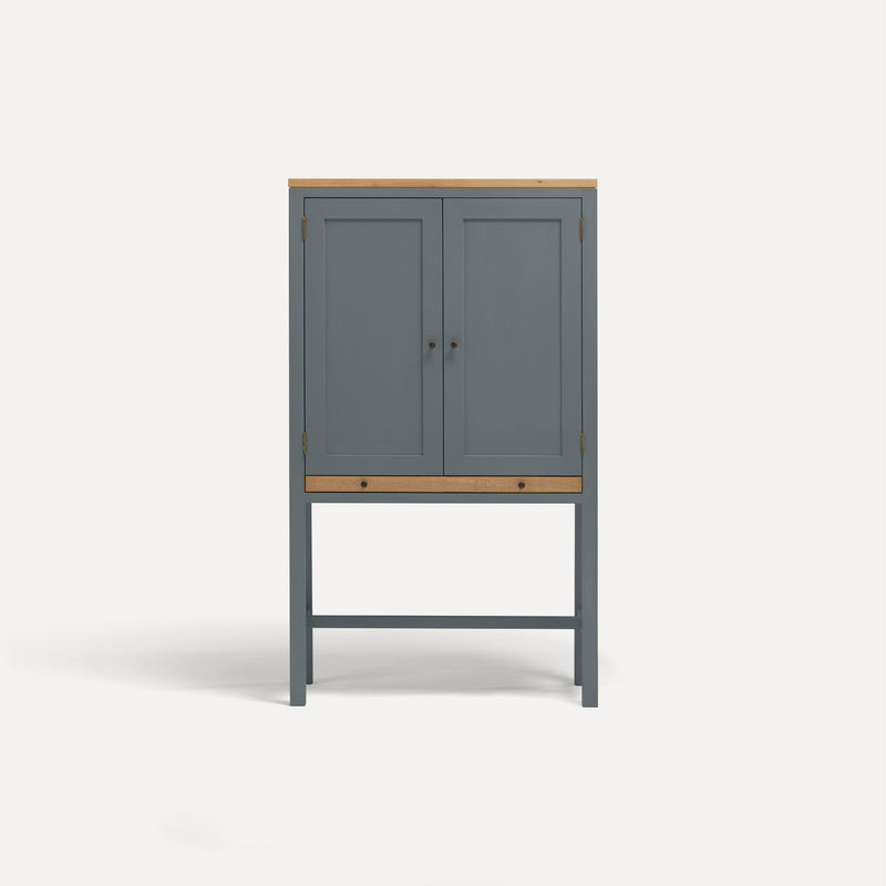 Blue painted two door shaker style cabinet on tall legs with oak work top. 
