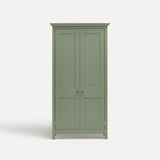 Green painted freestanding tall cupboard Shaker style with panelled doors black metal knobs.