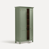 Green painted freestanding tall cupboard Shaker style with panelled doors black metal knobs. Shown at an angle with one door open revealing four shelves.