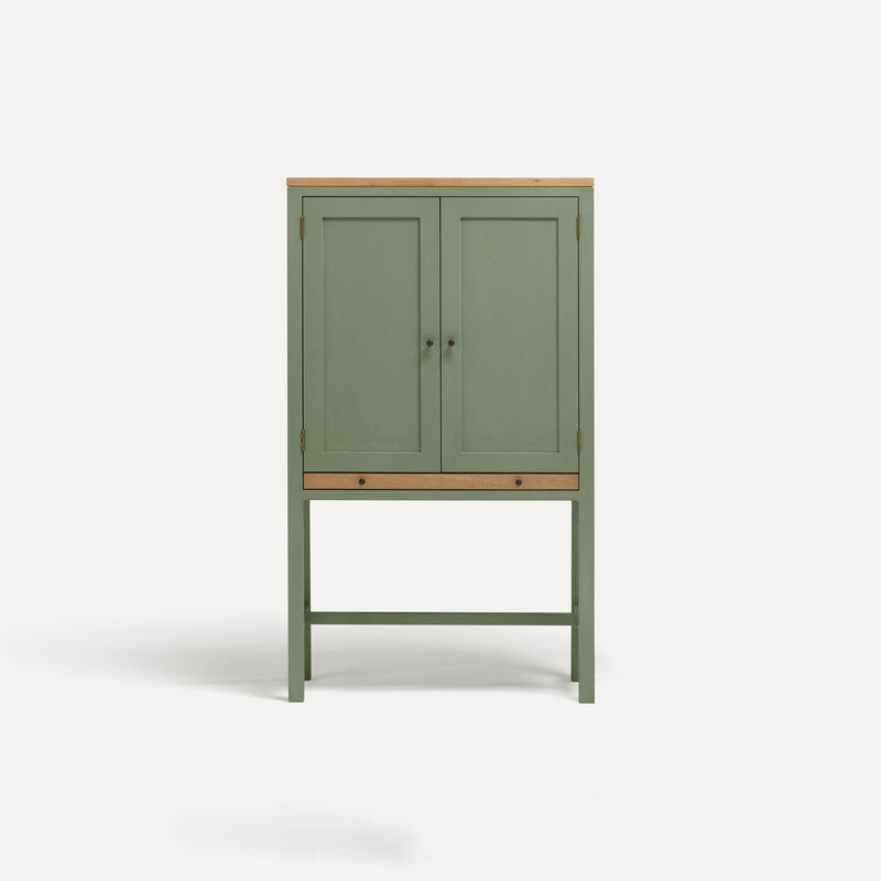 Green painted two door shaker style cabinet on tall legs with oak work top. 