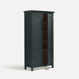 Dark grey blue painted freestanding tall cupboard Shaker style with panelled doors black metal knobs. Shown at an angle with one door open.