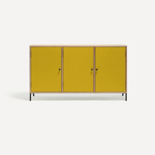 Three door ply wood contemporary side board with bright yellow painted doors, black metal knobs and feet. 