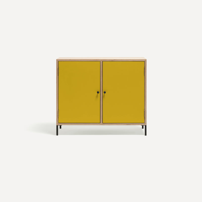 Two door ply wood contemporary side board with bold yellow painted doors, black metal knobs and feet. 