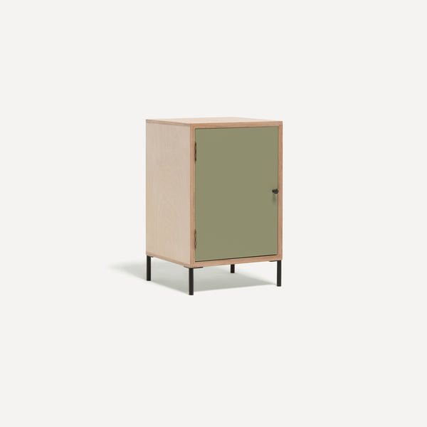 Single door ply wood contemporary bedside cabinet with green painted door, black metal door knobs and black metal legs. Shown at an angle.