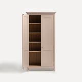 Pink painted freestanding tall cupboard Shaker style with panelled doors black metal knobs. One door open revealing oak interior and four shelves.